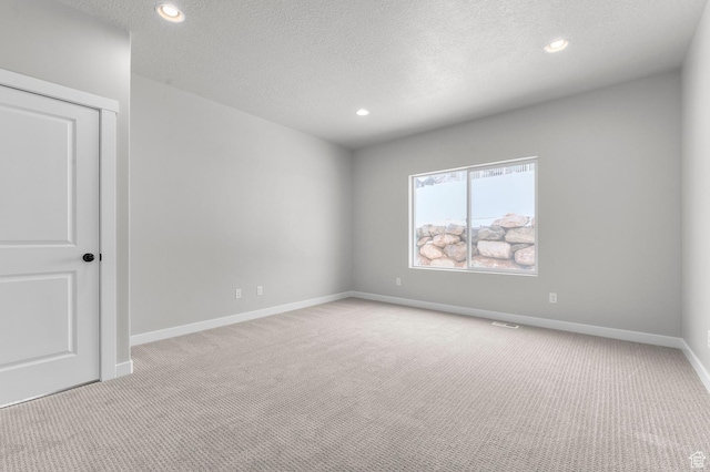 1470 N Shadow Wood Dr, Kaysville, UT 84037 - spare room featuring light carpet, a textured ceiling, baseboards, and recessed lighting