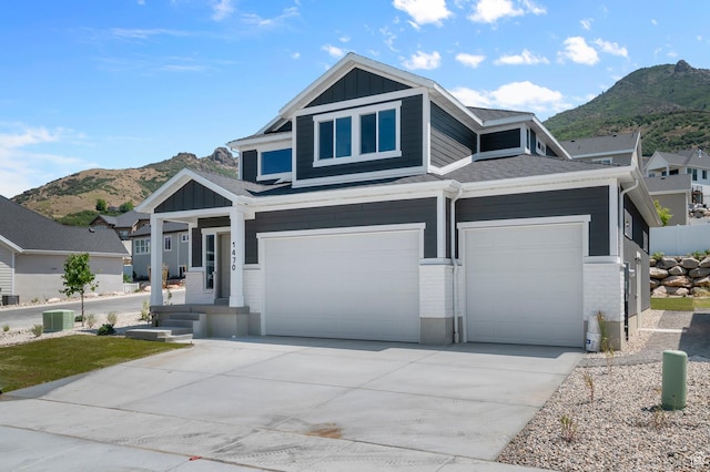 1470 N Shadow Wood Dr, Kaysville, UT 84037 - view of front facade featuring a mountain view, board and batten siding, driveway, and brick siding