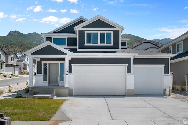 1470 N Shadow Wood Dr, Kaysville, UT 84037 - view of front of house featuring board and batten siding, a mountain view, driveway, and an attached garage