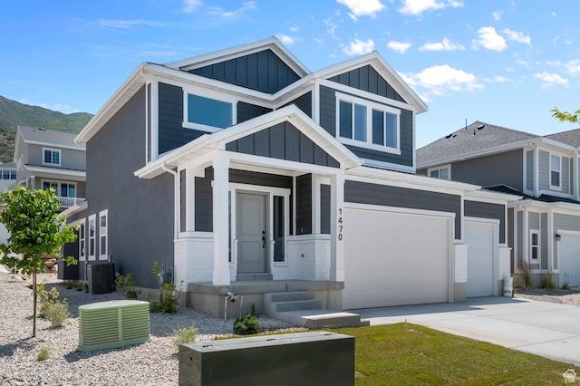 1470 N Shadow Wood Dr, Kaysville, UT 84037 - craftsman-style home featuring board and batten siding, concrete driveway, a garage, and a mountain view