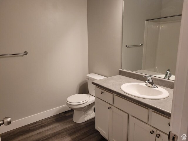 14474 Renner Ln Unit 302, Herriman, UT 84096 - bathroom featuring vanity, toilet, wood finished floors, and baseboards