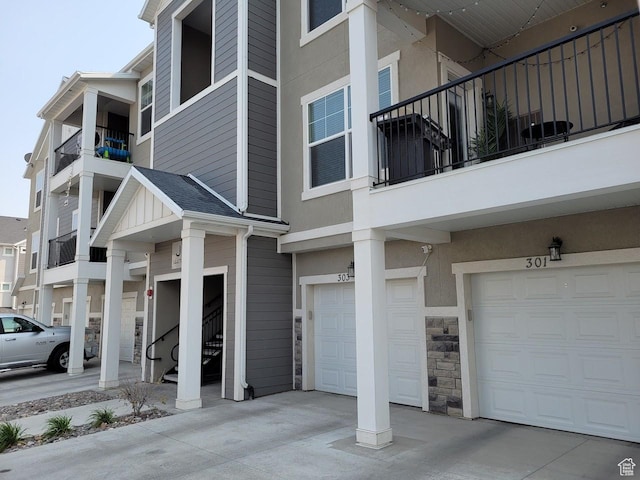 14474 Renner Ln Unit 302, Herriman, UT 84096 - view of property featuring a garage, driveway, and stairs
