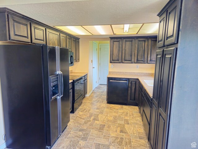 719 Adams St, Montpelier, ID 83254 - kitchen with black appliances, stone finish flooring, and light countertops