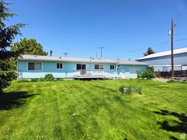 719 Adams St, Montpelier, ID 83254 - back of house with a wooden deck, a metal roof, and a yard