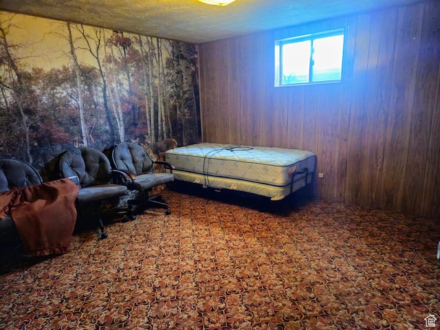 719 Adams St, Montpelier, ID 83254 - bedroom with wooden walls, carpet floors, and a textured ceiling