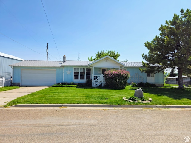 719 Adams St, Montpelier, ID 83254 - ranch-style house featuring a garage, concrete driveway, a front lawn, and a chimney