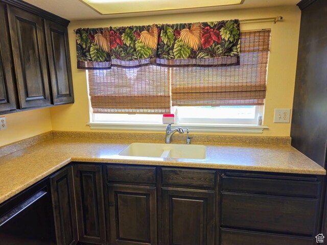 719 Adams St, Montpelier, ID 83254 - kitchen with black dishwasher, light countertops, and dark brown cabinetry