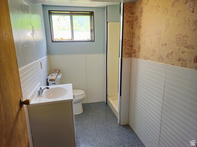 719 Adams St, Montpelier, ID 83254 - full bath with wainscoting, vanity, wallpapered walls, and a shower stall