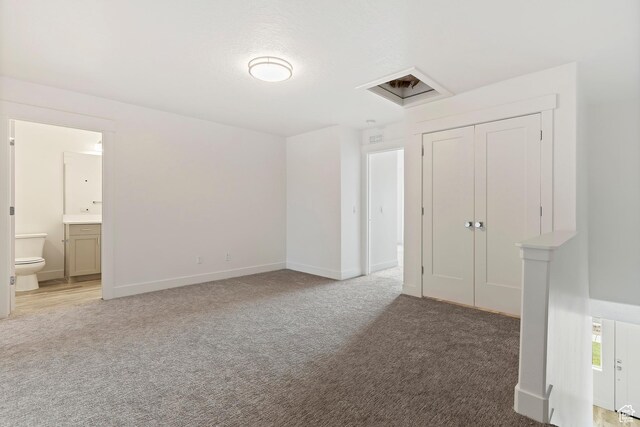 2734 S Allison Way Unit 213, Syracuse, UT 84075 - unfurnished bedroom with light carpet, baseboards, connected bathroom, and a closet