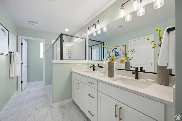 2854 S Ritter Row Unit 52, West Valley City, UT 84128 - full bath with double vanity, marble look tile flooring, baseboards, a shower stall, and a textured ceiling