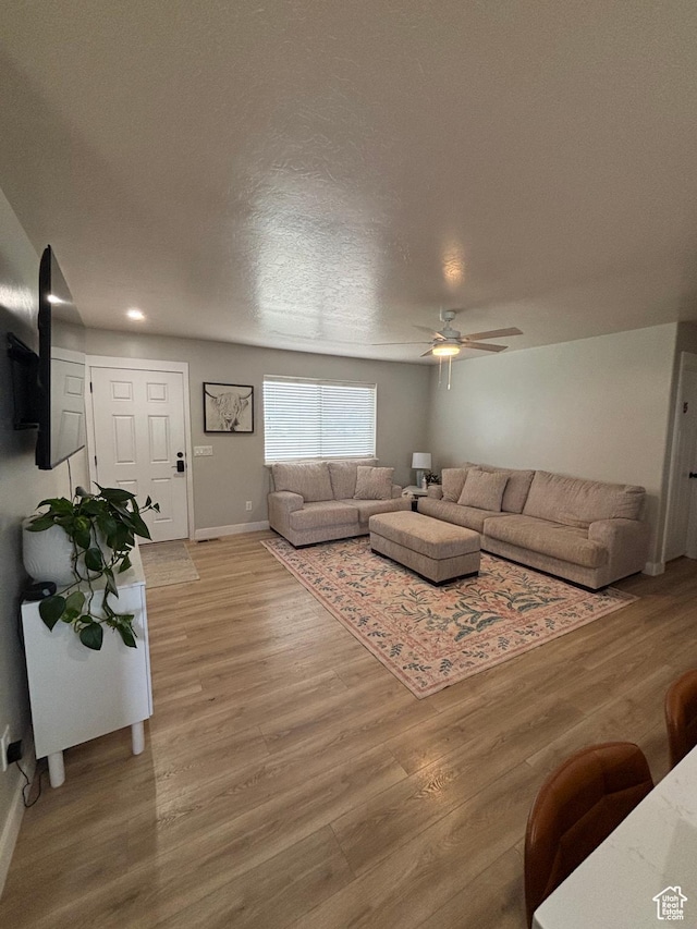 1574 S 2000 E, Vernal, UT 84078 - living room with a ceiling fan, light wood-style flooring, baseboards, and a textured ceiling