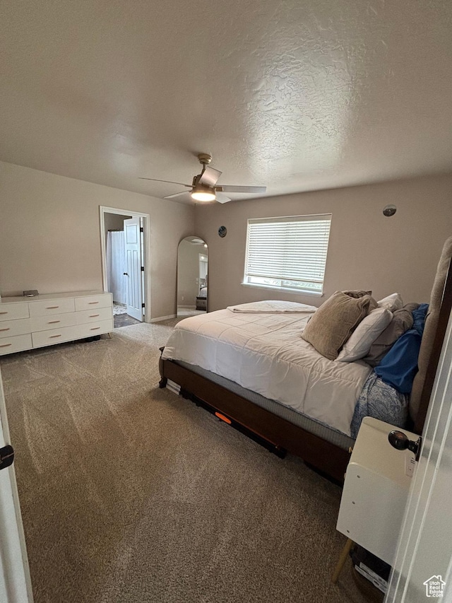 1574 S 2000 E, Vernal, UT 84078 - bedroom with arched walkways, carpet floors, ceiling fan, and a textured ceiling