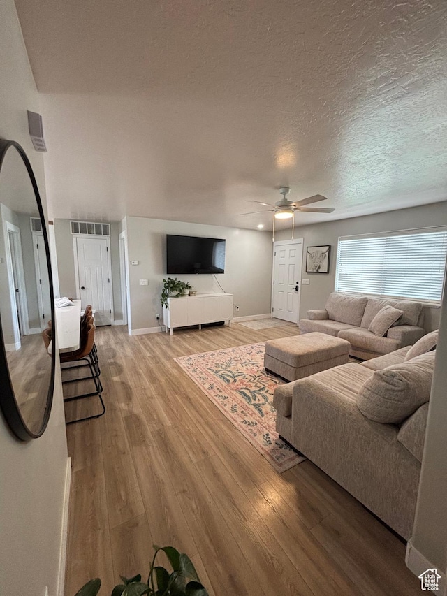 1574 S 2000 E, Vernal, UT 84078 - living area featuring ceiling fan, wood finished floors, baseboards, and a textured ceiling