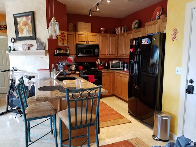 5420 N Bobsled Blvd Unit 202, Park City, UT 84098 - kitchen featuring black appliances, a peninsula, a sink, a kitchen bar, and light tile patterned flooring