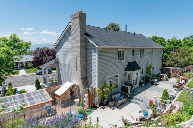 1814 N Heather Dr, Orem, UT 84097 - rear view of house featuring a chimney, a patio area, an outbuilding, an exterior structure, and a shingled roof