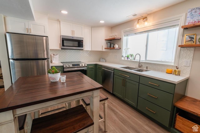 1814 N Heather Dr, Orem, UT 84097 - kitchen featuring green cabinets, stainless steel appliances, open shelves, white cabinetry, and recessed lighting