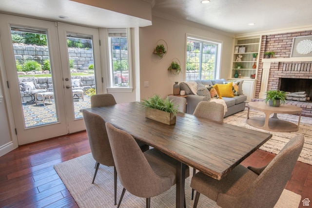 1814 N Heather Dr, Orem, UT 84097 - dining area featuring crown molding, wood-type flooring, french doors, recessed lighting, and a brick fireplace