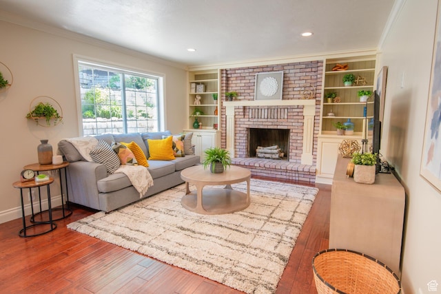 1814 N Heather Dr, Orem, UT 84097 - living room featuring ornamental molding, hardwood / wood-style flooring, a fireplace, built in features, and baseboards