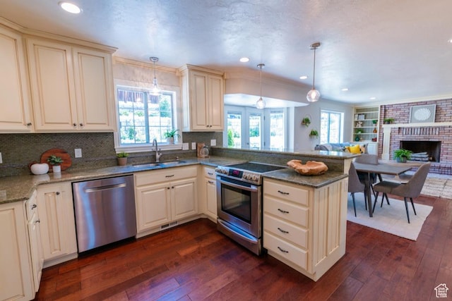 1814 N Heather Dr, Orem, UT 84097 - kitchen featuring appliances with stainless steel finishes, a sink, a peninsula, dark wood-style flooring, and open floor plan
