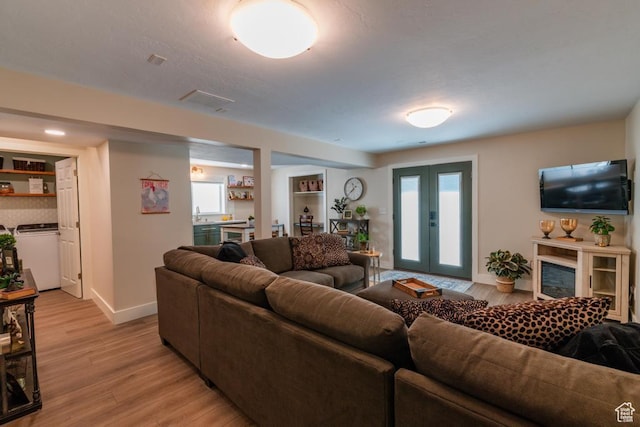 1814 N Heather Dr, Orem, UT 84097 - living room with washer / clothes dryer, light wood-style floors, and baseboards