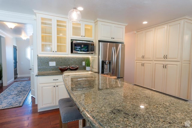 1814 N Heather Dr, Orem, UT 84097 - kitchen featuring stainless steel appliances, glass insert cabinets, dark stone counters, ornamental molding, and white cabinetry