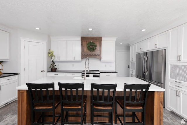 425 W 1080 S, Monroe, UT 84754 - kitchen featuring appliances with stainless steel finishes, wood finished floors, a kitchen island with sink, white cabinetry, and recessed lighting