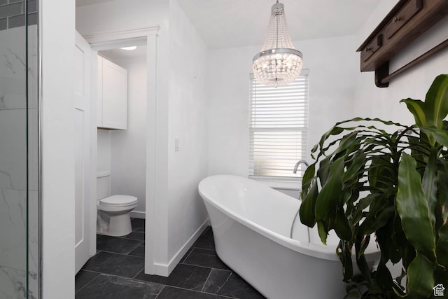 425 W 1080 S, Monroe, UT 84754 - bathroom featuring a freestanding tub, toilet, a chandelier, and baseboards