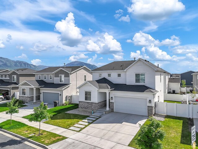 1797 N Avocet Dr, Salem, UT 84653 - view of front of property with stone siding, a residential view, concrete driveway, and an attached garage