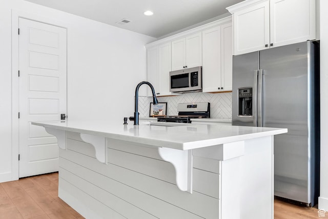 1797 N Avocet Dr, Salem, UT 84653 - kitchen with stainless steel appliances, light wood finished floors, white cabinetry, and recessed lighting