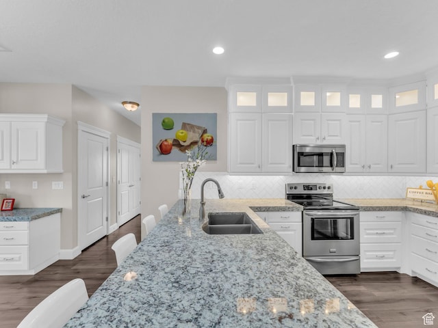 10486 S Harvest Glory Dr W Unit 125, South Jordan, UT 84095 - kitchen with stainless steel appliances, a sink, light stone countertops, decorative backsplash, and recessed lighting