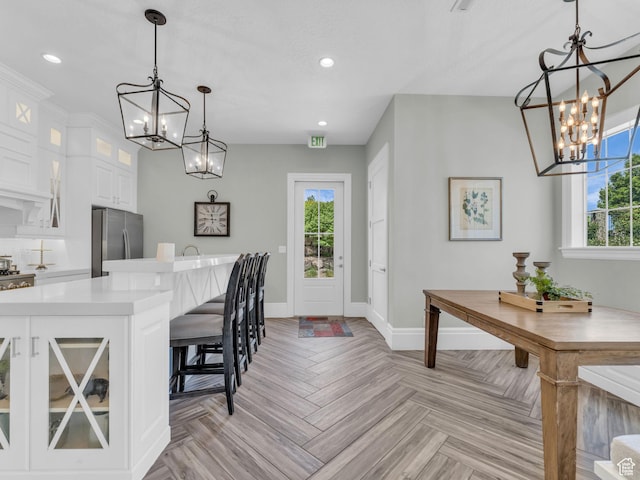 10486 S Harvest Glory Dr W Unit 125, South Jordan, UT 84095 - dining space with a chandelier, baseboards, healthy amount of natural light, and recessed lighting