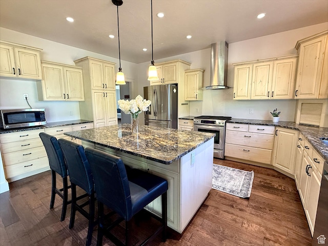 2307 Maple Leaf Dr, Cove, UT 84320 - kitchen with appliances with stainless steel finishes, wall chimney exhaust hood, a center island, dark wood-type flooring, and dark stone counters