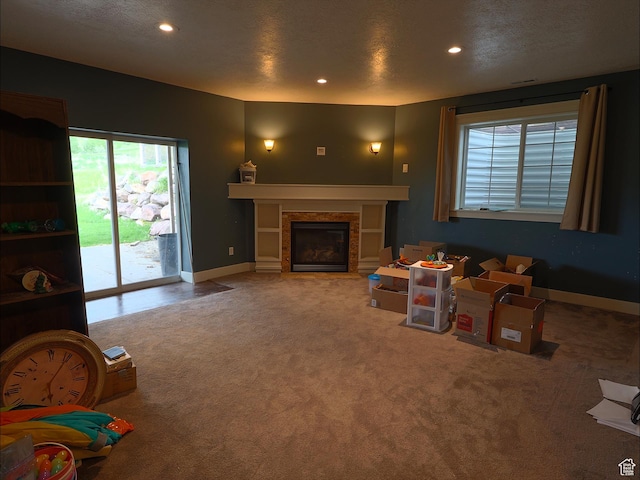 2307 Maple Leaf Dr, Cove, UT 84320 - carpeted living area featuring a glass covered fireplace, recessed lighting, and baseboards