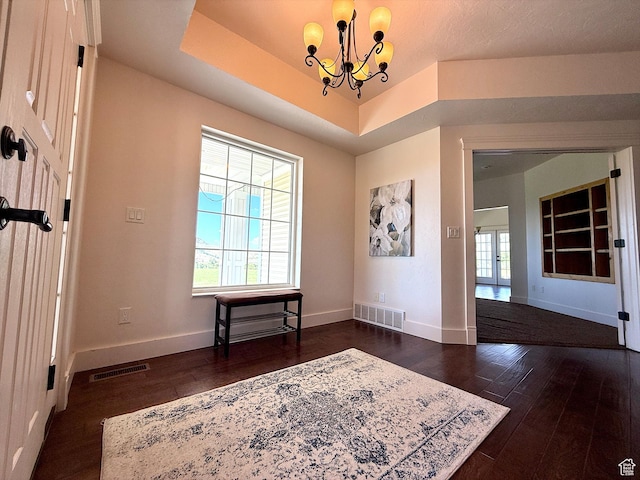 2307 Maple Leaf Dr, Cove, UT 84320 - entryway featuring dark wood-style flooring, a chandelier, and a raised ceiling