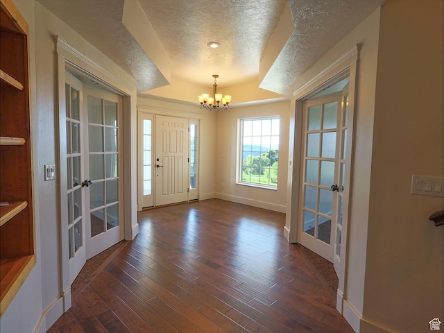 2307 Maple Leaf Dr, Cove, UT 84320 - entrance foyer with french doors, a chandelier, a textured ceiling, dark wood-style flooring, and baseboards