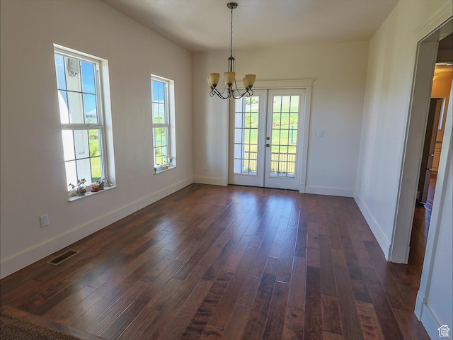 2307 Maple Leaf Dr, Cove, UT 84320 - unfurnished dining area featuring a chandelier, dark wood-style flooring, baseboards, and french doors