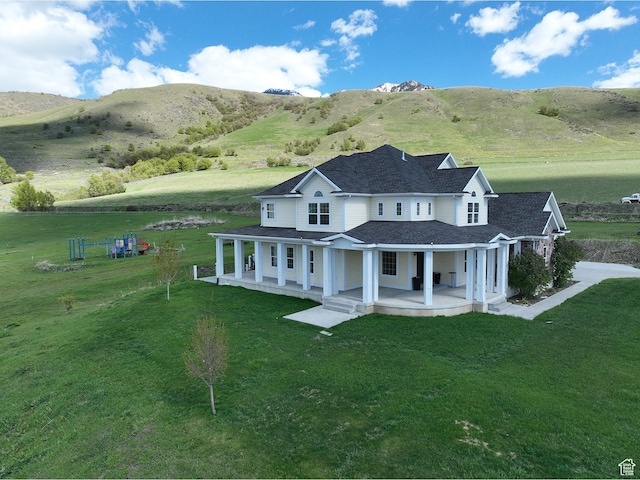 2307 Maple Leaf Dr, Cove, UT 84320 - rear view of house featuring covered porch, a yard, and a mountain view
