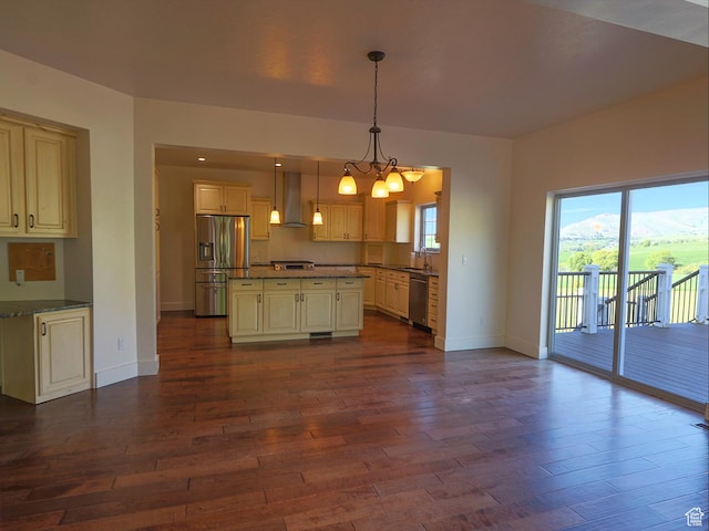 2307 Maple Leaf Dr, Cove, UT 84320 - kitchen featuring appliances with stainless steel finishes, wall chimney range hood, a sink, dark wood-type flooring, and baseboards