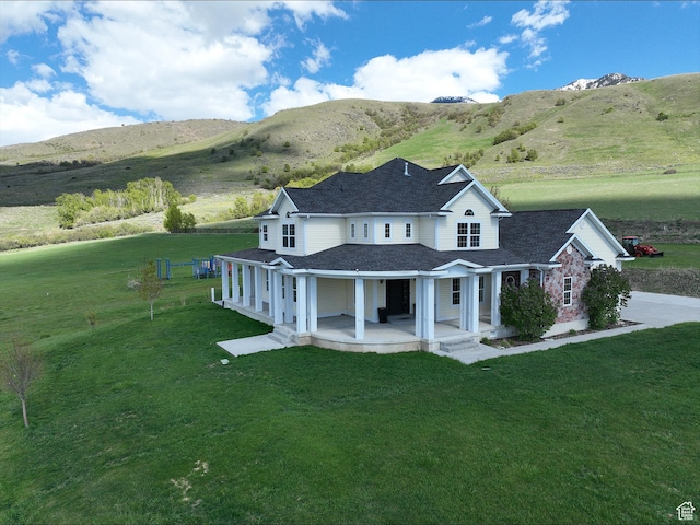 2307 Maple Leaf Dr, Cove, UT 84320 - back of property with covered porch, a lawn, a shingled roof, and a mountain view