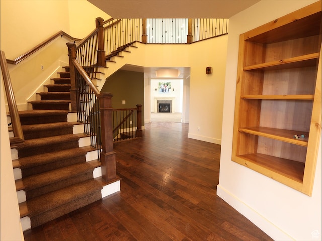 2307 Maple Leaf Dr, Cove, UT 84320 - stairs featuring baseboards, hardwood / wood-style flooring, and a towering ceiling