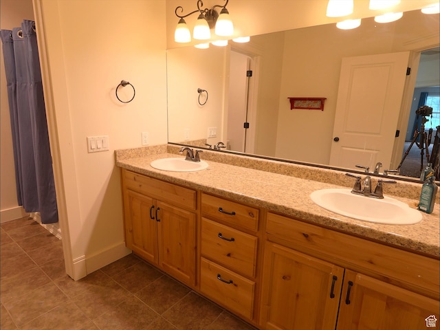2307 Maple Leaf Dr, Cove, UT 84320 - bathroom with double vanity, tile patterned floors, and baseboards