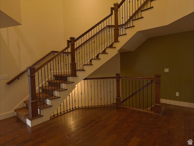 2307 Maple Leaf Dr, Cove, UT 84320 - stairway featuring a towering ceiling, hardwood / wood-style flooring, and baseboards