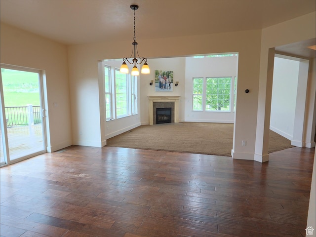 2307 Maple Leaf Dr, Cove, UT 84320 - unfurnished living room featuring baseboards, a fireplace, a chandelier, and dark wood finished floors
