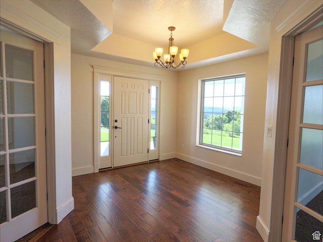 2307 Maple Leaf Dr, Cove, UT 84320 - foyer entrance featuring a tray ceiling, a chandelier, plenty of natural light, and baseboards