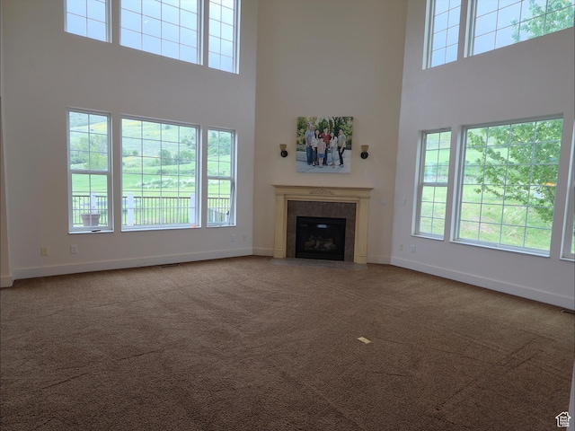 2307 Maple Leaf Dr, Cove, UT 84320 - unfurnished living room with a towering ceiling, healthy amount of natural light, baseboards, and carpet
