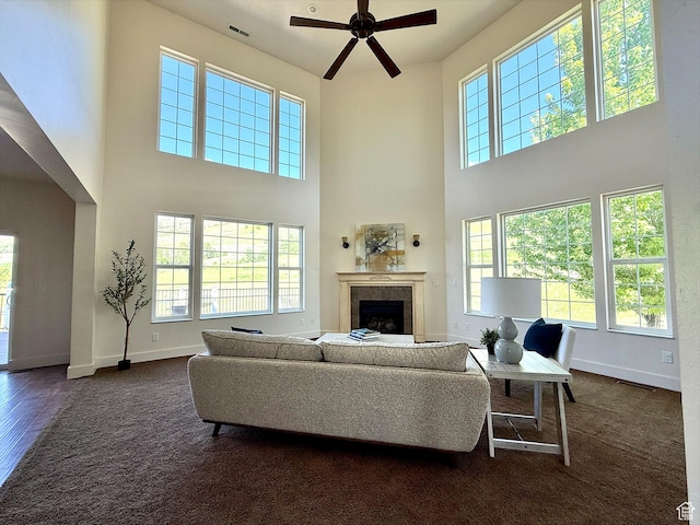 2307 Maple Leaf Dr, Cove, UT 84320 - living area with a high ceiling, a ceiling fan, a fireplace, and dark wood finished floors