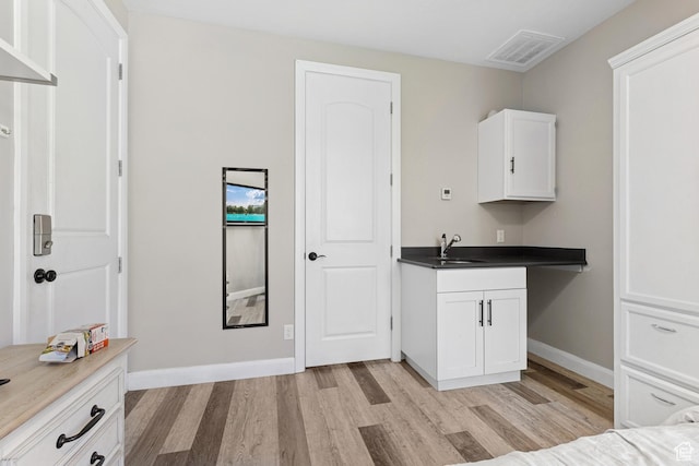 536 N Creek Cir, Washington, UT 84780 - kitchen with light wood-style floors, white cabinets, baseboards, and a sink
