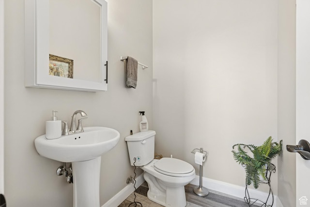 536 N Creek Cir, Washington, UT 84780 - half bathroom featuring baseboards, toilet, wood finished floors, and a sink