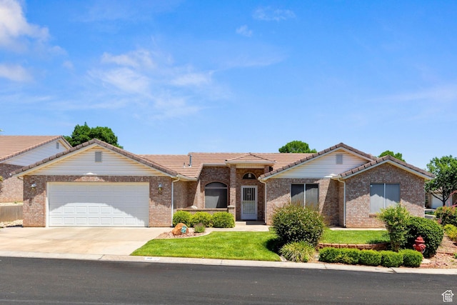 1040 S 1100 E Unit 80, St George, UT 84790 - ranch-style home with a tiled roof, an attached garage, concrete driveway, and a front yard