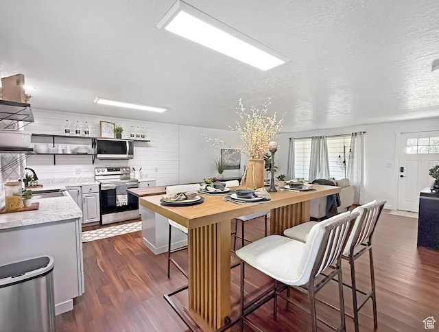 5432 S 800 E, South Ogden, UT 84405 - kitchen featuring stainless steel appliances, a sink, open shelves, dark wood-type flooring, and a kitchen breakfast bar